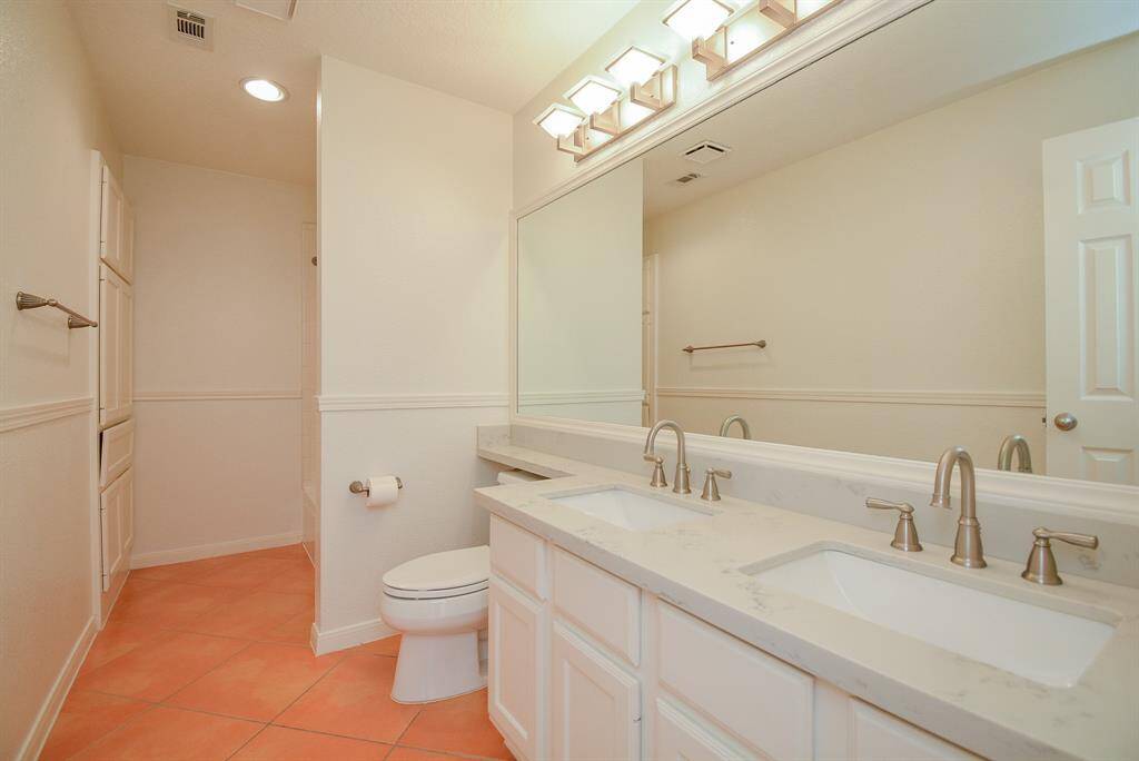 Secondary bathroom features beautiful quartz countertops and double sinks