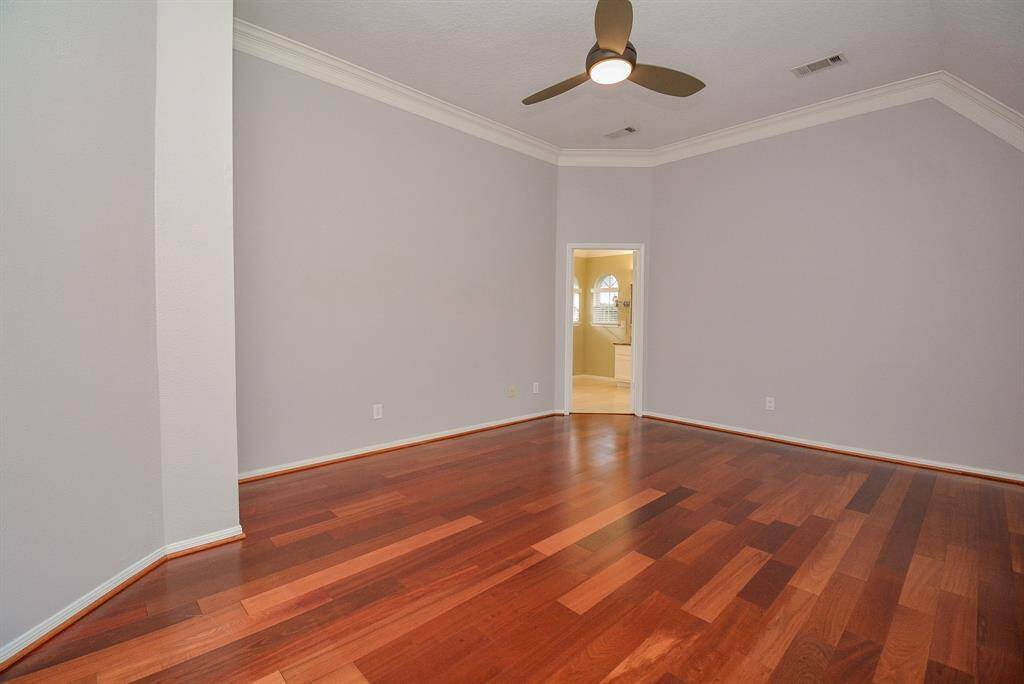 View to the bathroom entrance. Energy efficient ceiling fan