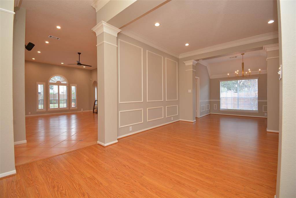 Upon entering you will find the ample formal living and dinging rooms to the right and the family room across the foyer.  Easy care flooring features laminated floors in the formals and Saltillo tile in the family room and kitchen.