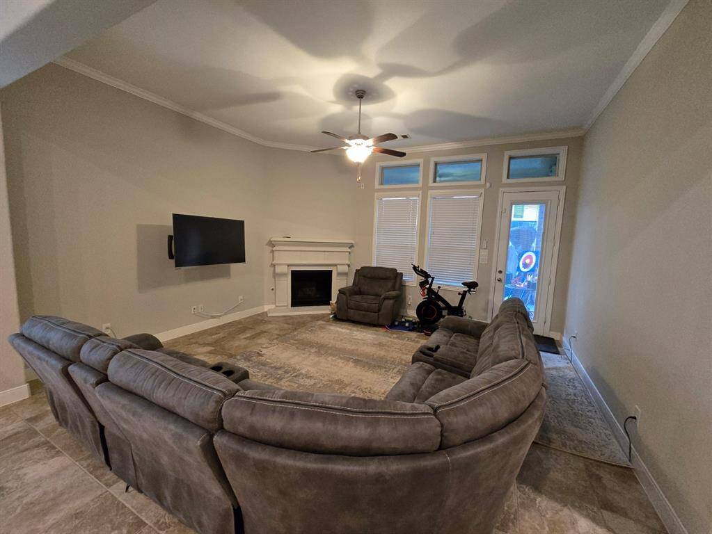 This bright and open living area is made even more inviting by the beautiful fireplace. A perfect spot to relax and enjoy the company of loved ones.