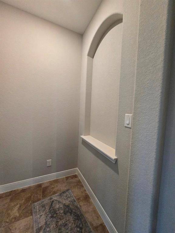 Just beyond this stylish built-in niche lies the tranquility of the primary bedroom.  A beautiful transition into your private space.