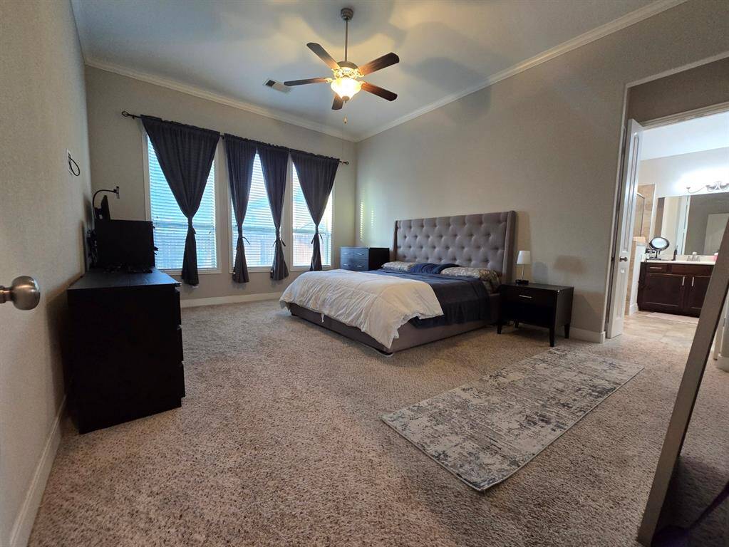 This expansive primary bedroom provides a great amount of space for rest and relaxation.