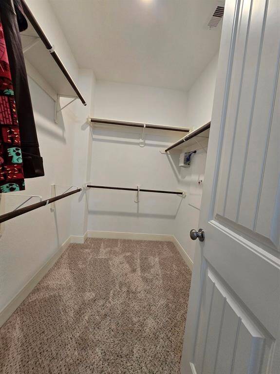 Enjoy the convenience of two large walk-in closets in the primary bedroom, with this one being the smaller of the two.
