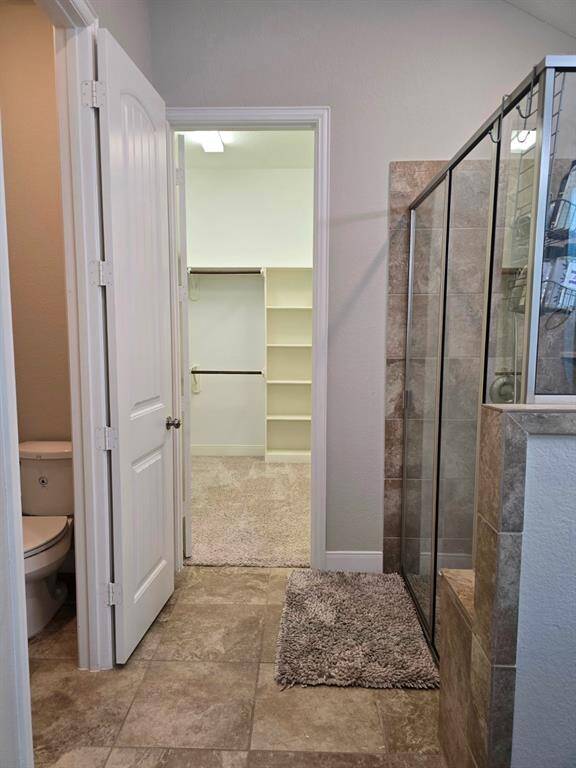 Enjoy substantial storage in this generously sized walk-in closet, found on the other side of the primary bathroom.