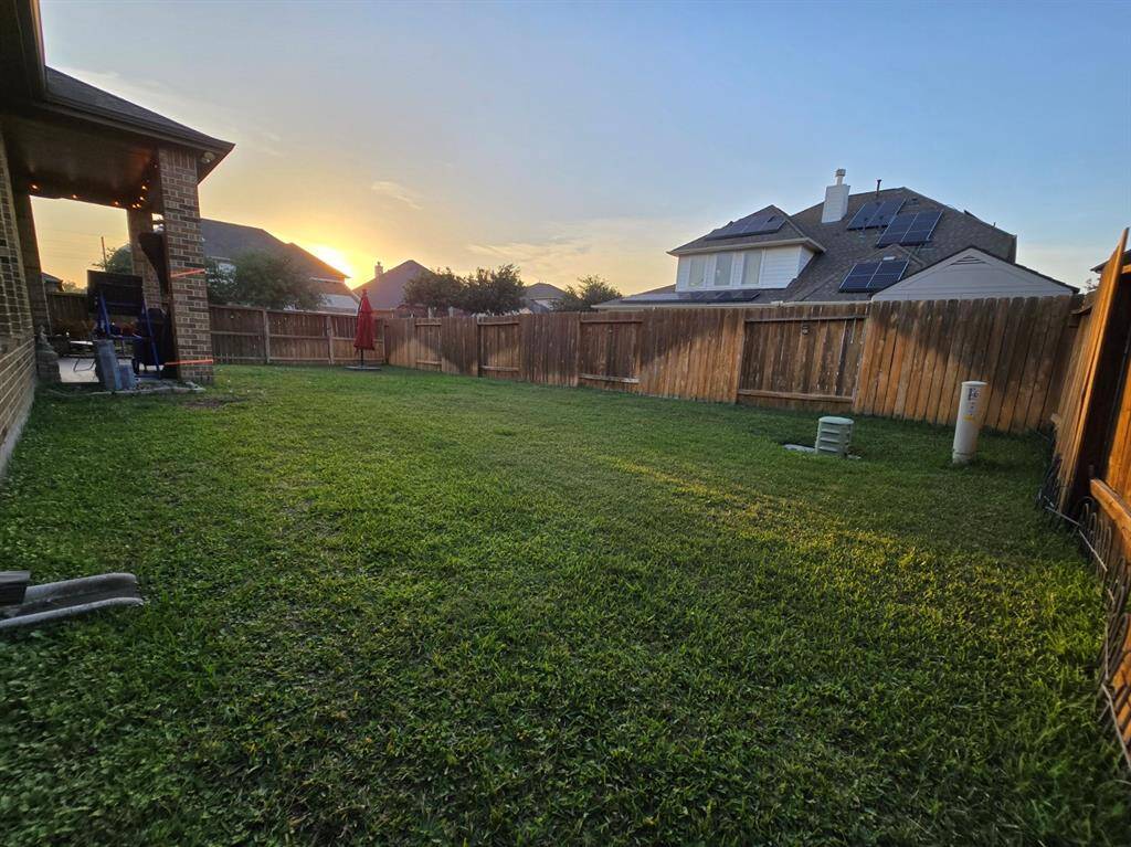This large backyard offers endless possibilities for gardening, entertaining, and play.