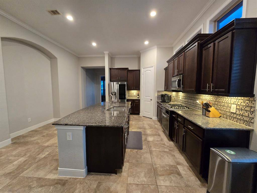Stainless steel appliances, granite counter tops, and plenty of counter space make this kitchen a standout.