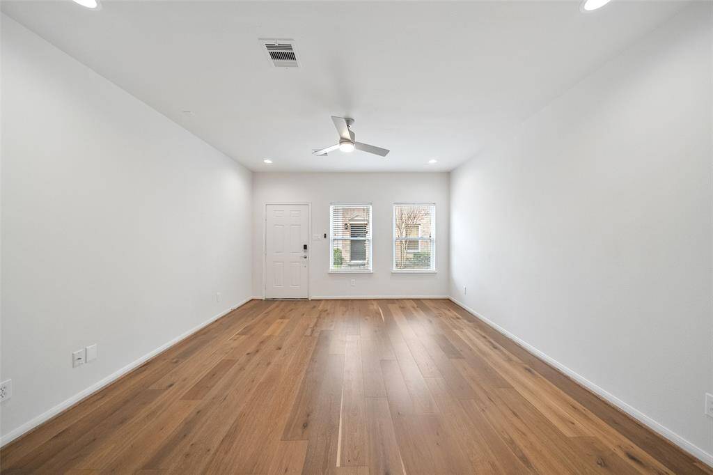 The view from the kitchen highlights the stunning new wide plank flooring throughout the first floor.