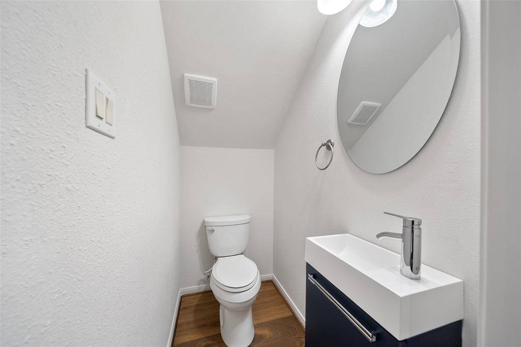Conveniently located just off the kitchen, this sleek half bath is perfectly placed for both you and your guests.