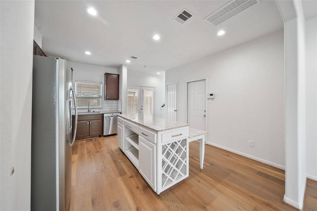 The custom island features a built-in wine rack and extra storage, perfect for all your cooking essentials.