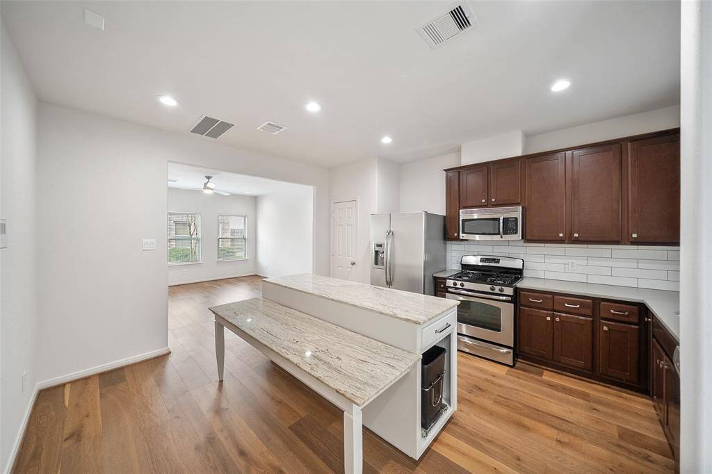 This view highlights the spacious and seamless kitchen layout. (Cabinet door ordered)
