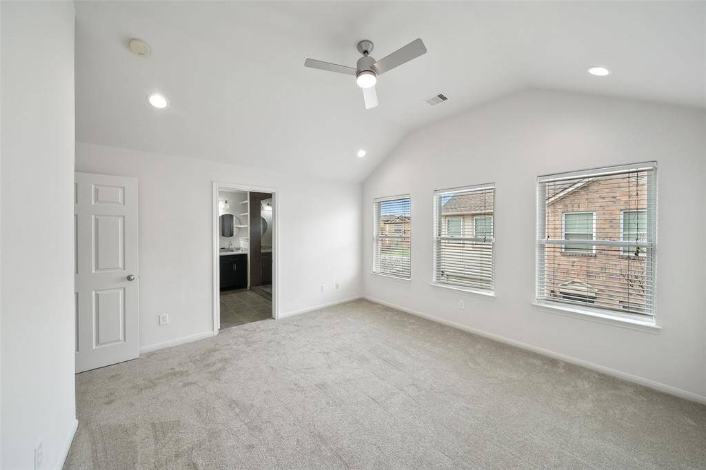 The primary suite boasts three beautiful windows, flooding the room with an abundance of natural light.