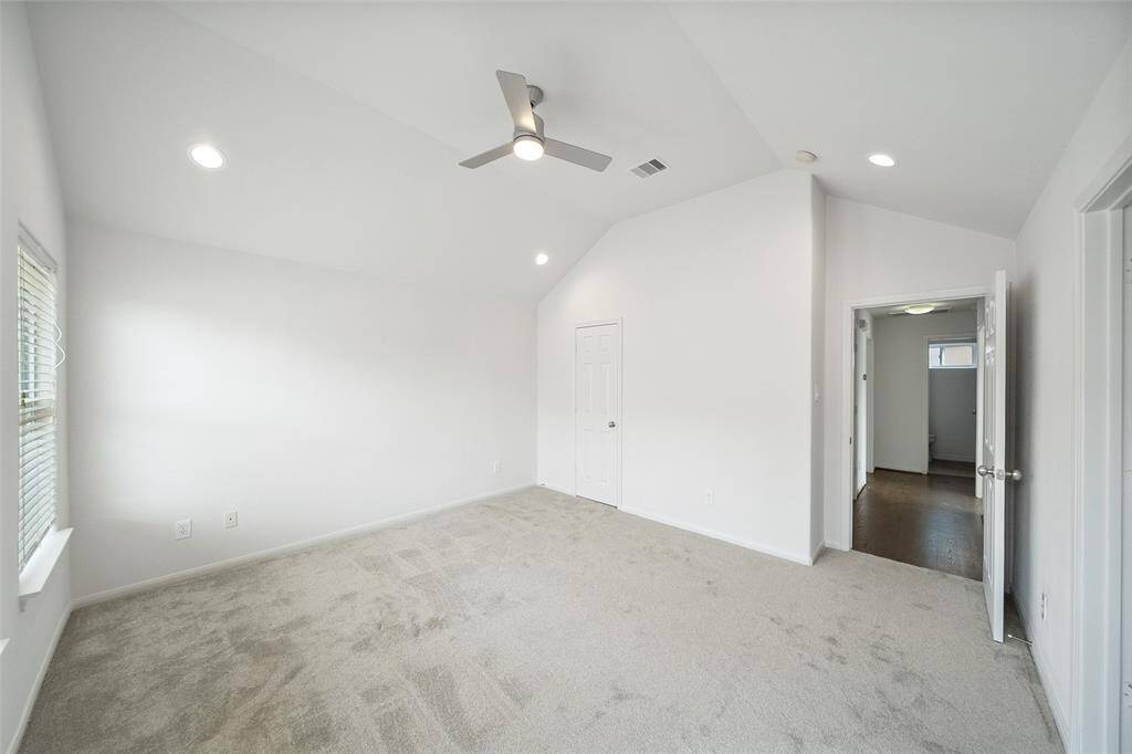 An additional view highlights the vaulted ceiling in the primary suite, adding to its spaciousness and charm.
