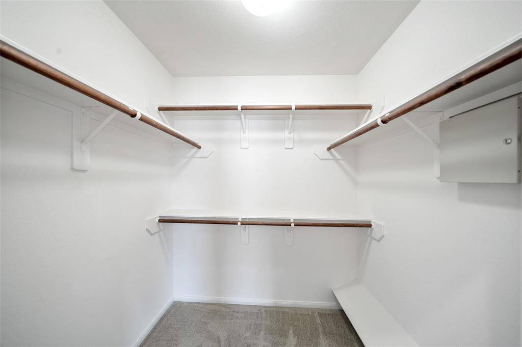 The primary closet is spacious, featuring rack space, shelving, and dedicated shoe storage.