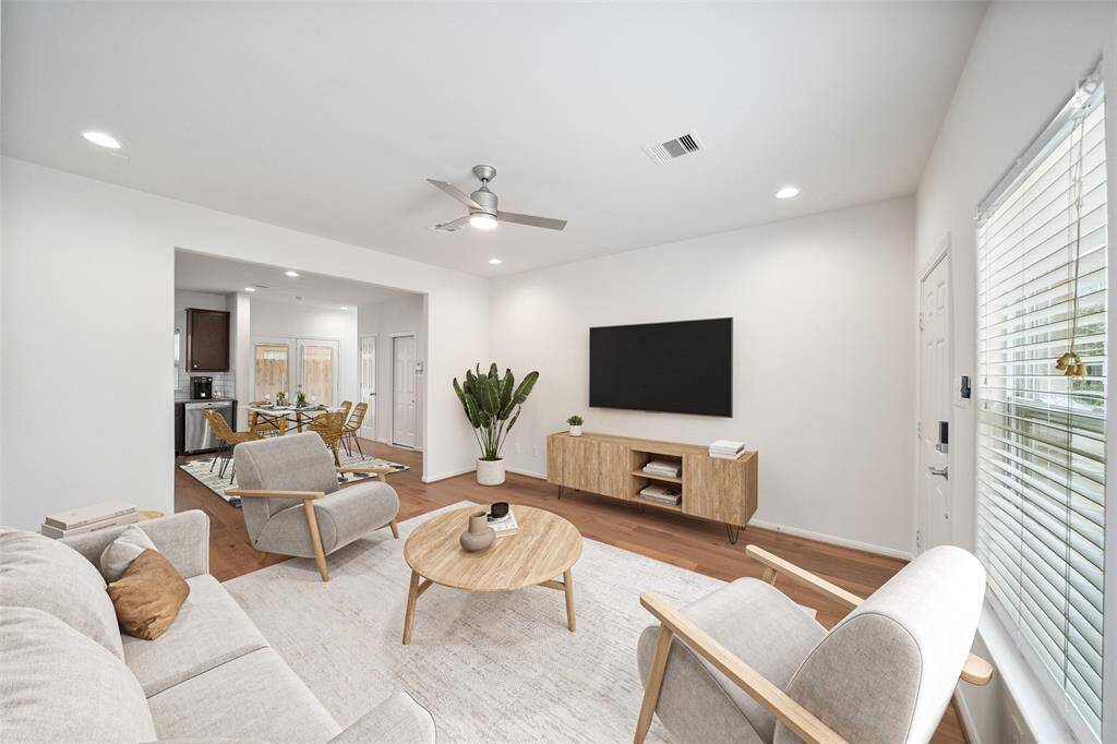 Here is additional view with the kitchen island removed and a dining table perfectly situated in the kitchen. *virtually staged