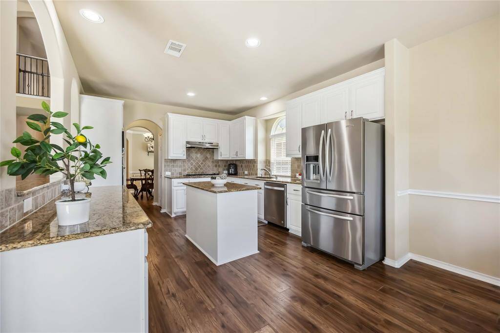 Large kitchen with granite counters overlooking the family room.