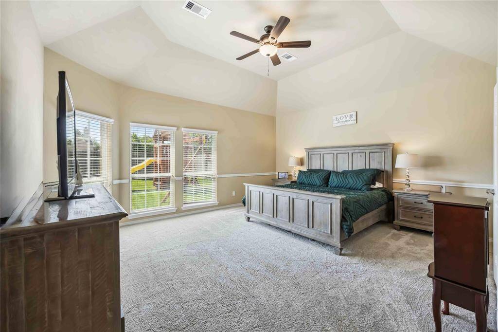 Oversized primary retreat with vaulted recessed ceilings.