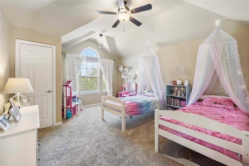 Large secondary bedroom with vaulted ceilings, and great window coverage add to the charm of the room.