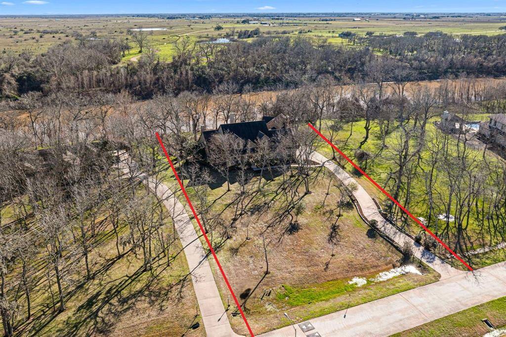 Situated behind a 24-hour manned gate in the prestigious Golf-Course community of Weston Lakes, this exceptional home rests beneath a canopy of majestic Pecan, Oak and Elm trees. Spanning 1.74 wooded acres, the property backs to the Brazos River, with no rear neighbors in sight offering breathtaking views and a serene natural park-like setting. Please note, the property lines are approximate.