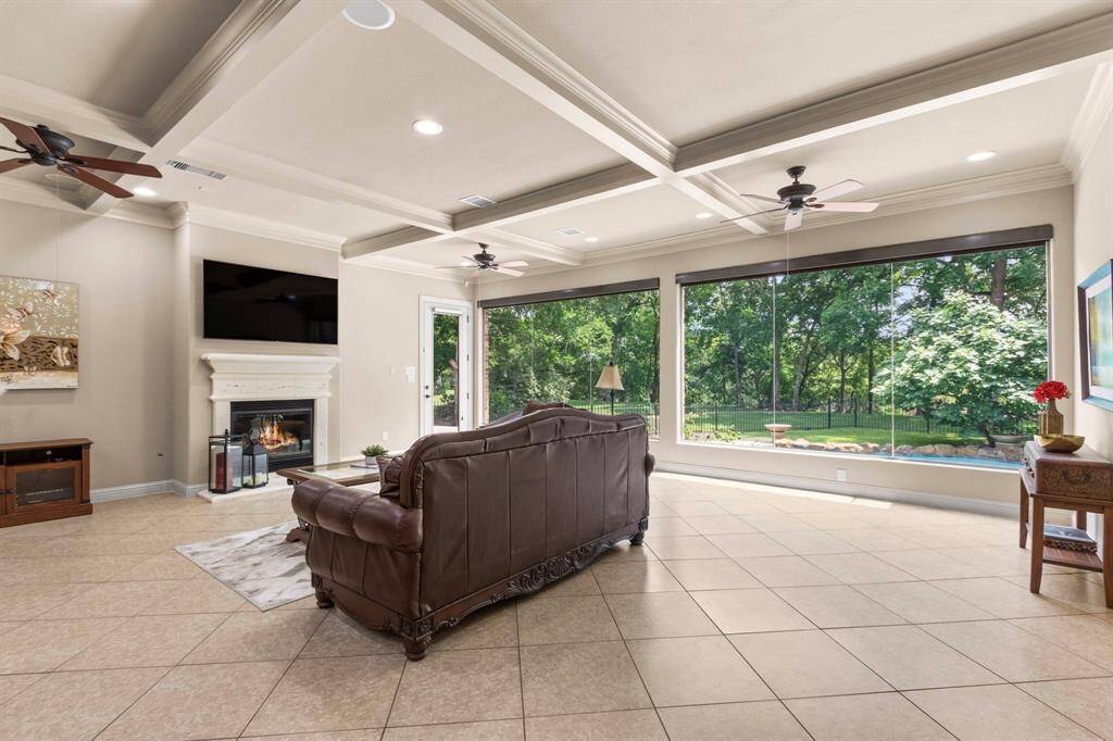 The Family Room also features a striking cast iron Fireplace as its focal point, complete with a conveniently placed electrical outlet above for mounting your TV. Four ceiling speakers are also installed, perfect for creating an immersive entertainment experience.