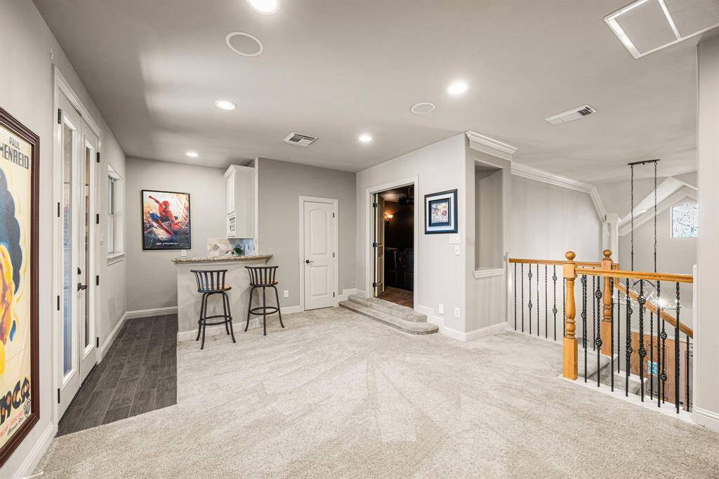 As you make your way upstairs, you are welcomed into the spacious Game Room, complete with a beverage area with bar featuring a granite countertop, undermount sink, and sleek off-white cabinets. This inviting space is perfect for entertaining and also includes its own private screened-in balcony, providing a serene spot to take in the breathtaking views.