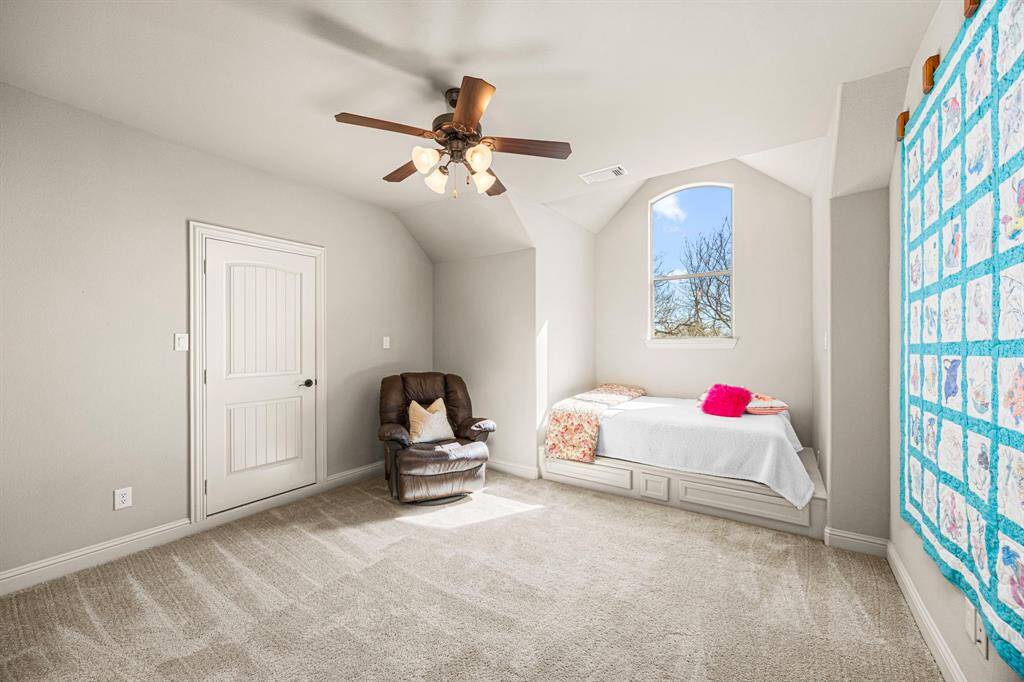 The upstairs Secondary Bedrooms each feature a built-in platform bed area designed to accommodate a full or queen-size bed, with a large, picturesque window above that fills the space with natural light. Soft, lush carpeting enhances the comfort of these rooms, and each has direct access to a well-appointed Jack and Jill bath, offering both convenience and privacy.