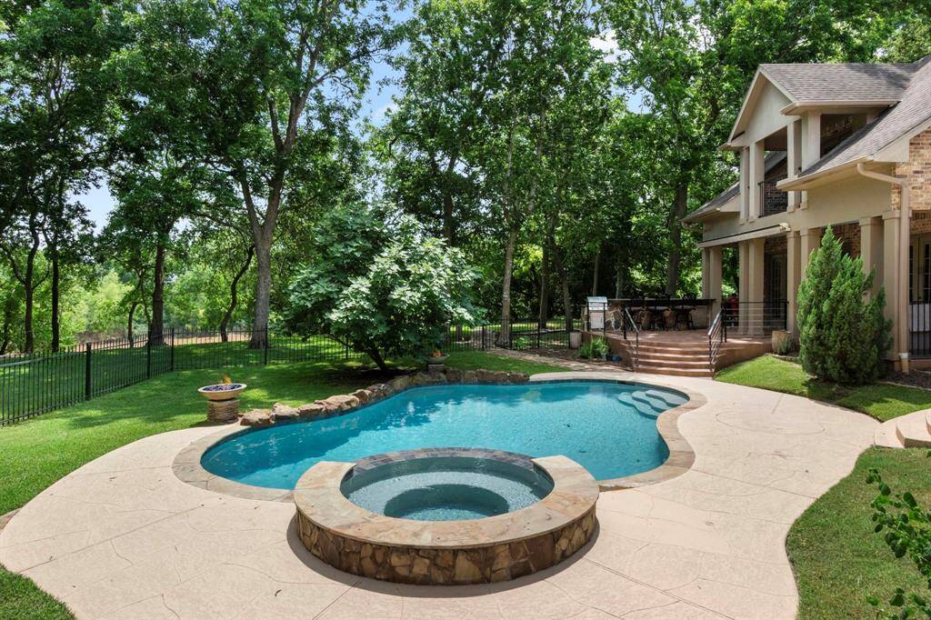 Step outside to a resort-style playground with breathtaking views that stretch as far as the eye can see. The sparkling Pool and Spa are perfectly positioned against the scenic backdrop of the Brazos River. A wrought iron fence surrounds the pool area—ideal for keeping your furry friends safe while you relax or entertain. Don’t miss the elegant spiral staircase that descends from the second-floor balcony to the backyard, combining both style and convenience.