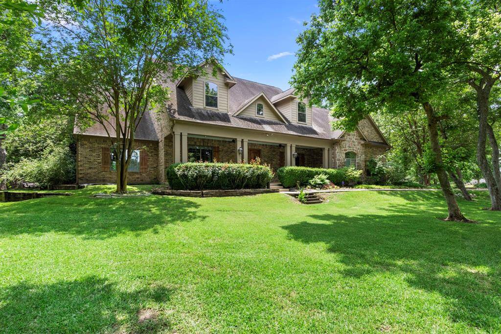 The gable roofline and stone-brick exterior create a timeless curb appeal, while the windows, adorned with charming shutters, add character and elegance. This beautifully designed home seamlessly blends classic architecture with modern comforts, making it a true standout.