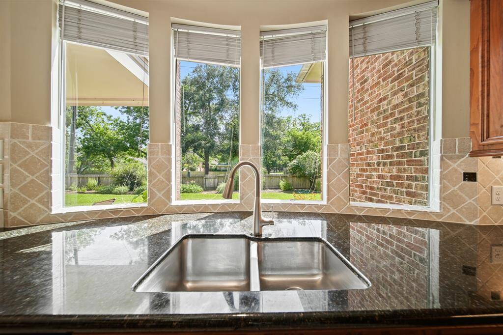 The Breakfast Area is Surrounded by Large Windows and is Conveniently Located Next to the Kitchen.