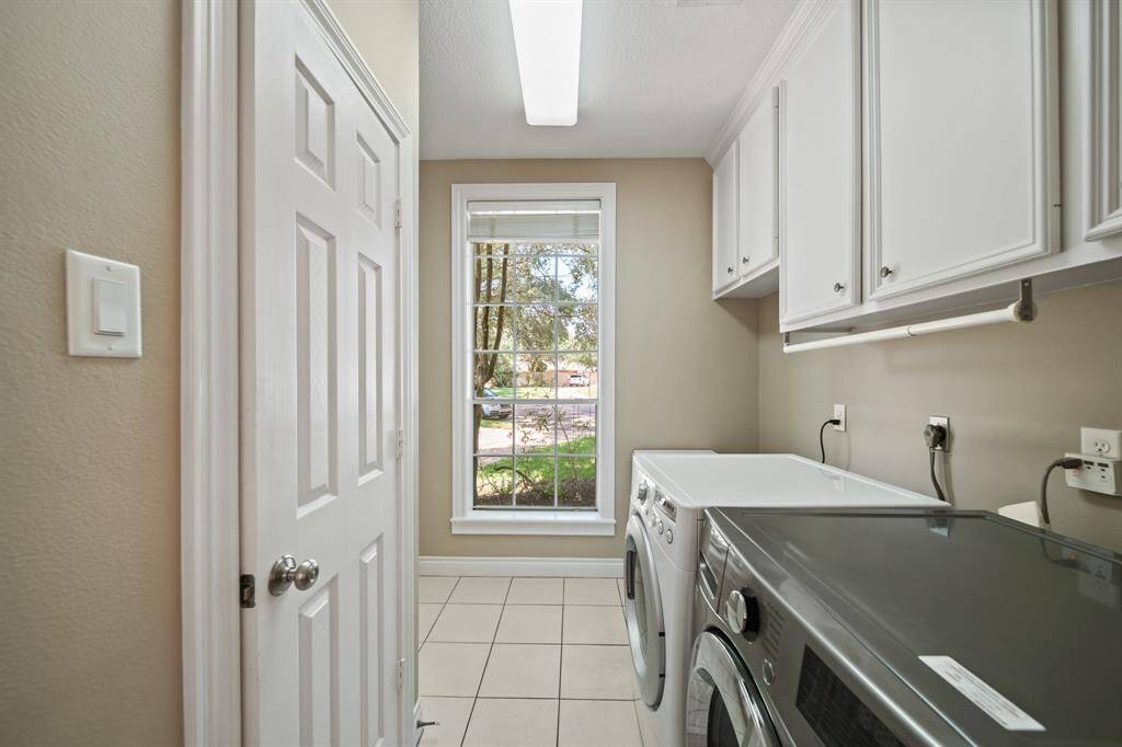 Spacious Utility Room off of the Kitchen with Large closet and built in cabinet.