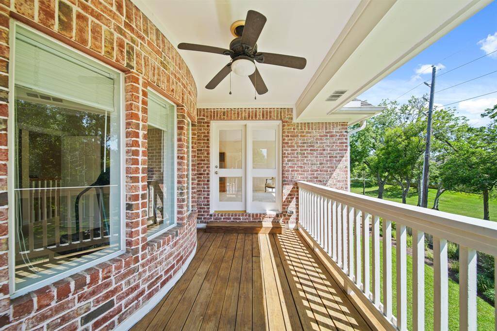 Spacious Primary Bedroom Located Upstairs with a Trayed Ceiling and Private Door Access to Balcony.