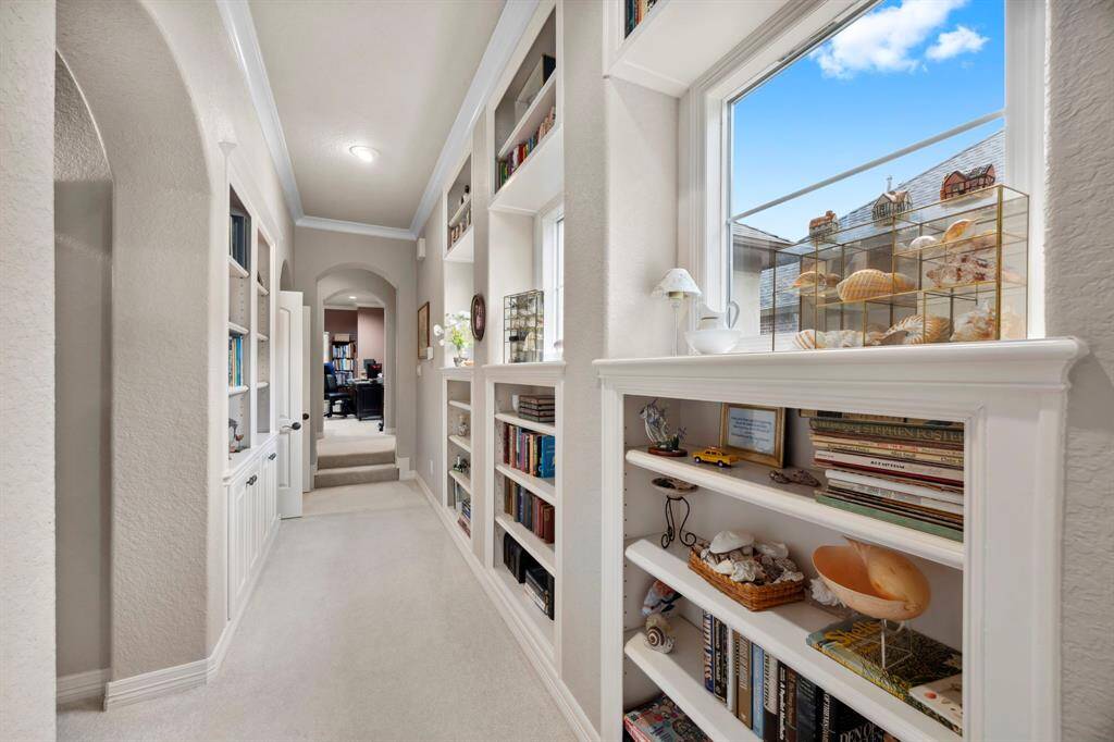 The main hallway upstairs features incredible built in storage and is full of natural light.