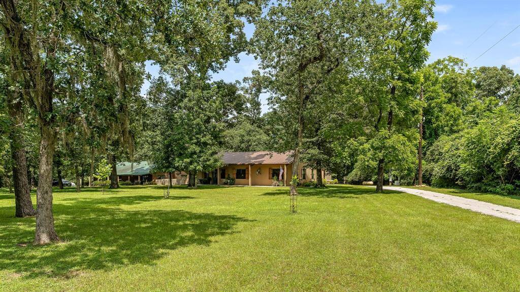 Home 1 is a ranch style single-story home nestled on lush acreage, tree-lined property with open spaces and a welcoming, natural ambiance.