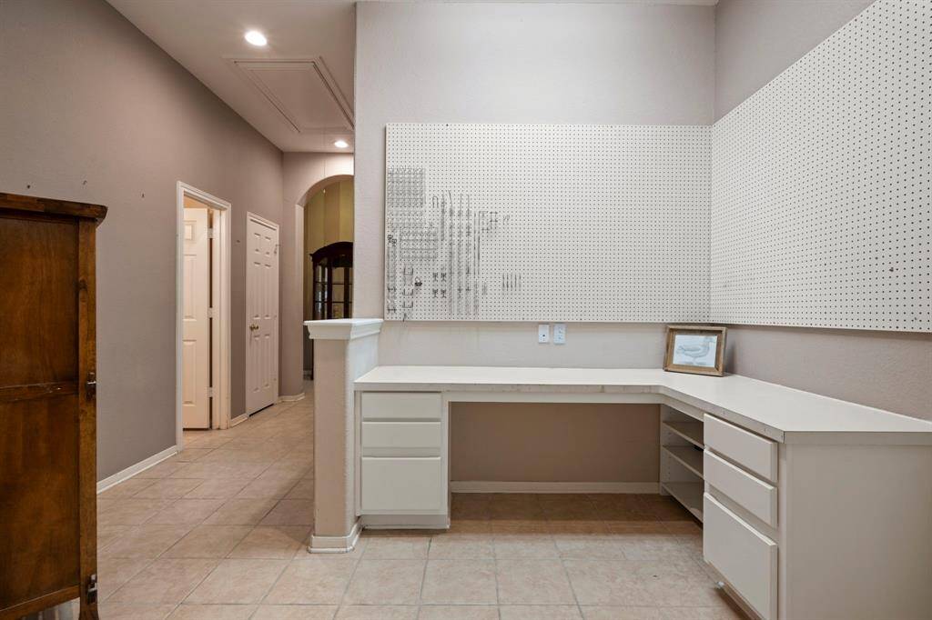Versatile space with high ceilings and ample lighting, perfect for a study or crafting.