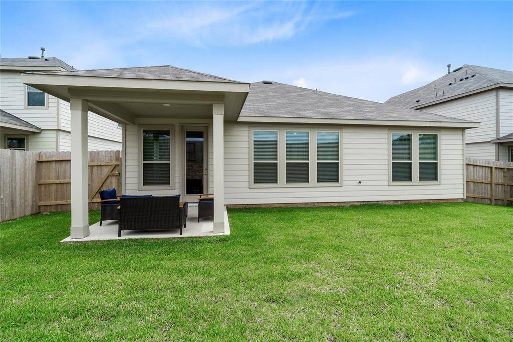 Come and see this spacious backyard with its beautiful covered patio. There is plenty of room for the kids to play and adults to relax!