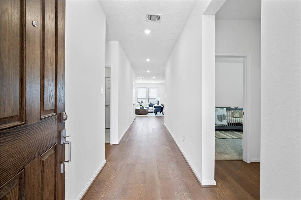 Welcome to your new home at 3524 Sage Green Trail. You are greeted with this beautiful entryway featuring gorgeous engineered wood flooring, recessed lighting and custom paint.