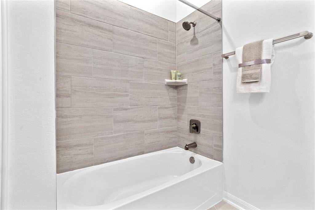 Secondary bedroom features plush carpet, neutral paint, lighting, large window with privacy blinds and ample sized closet space.