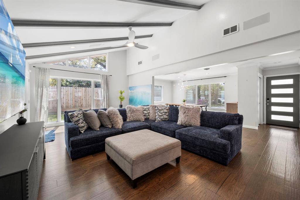 Soaring ceilings with exposed wood beams and expansive windows enhance the open floor plan, creating a perfect balance of grandeur and warmth.