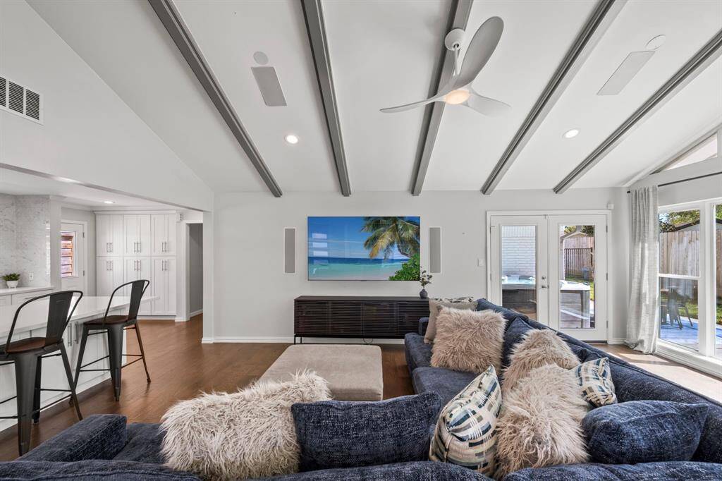 The spacious family room easily accommodates large furniture and a full-size media setup. Just beyond the back door, a side patio and seating area offer the perfect spot for grilling and al fresco dining.