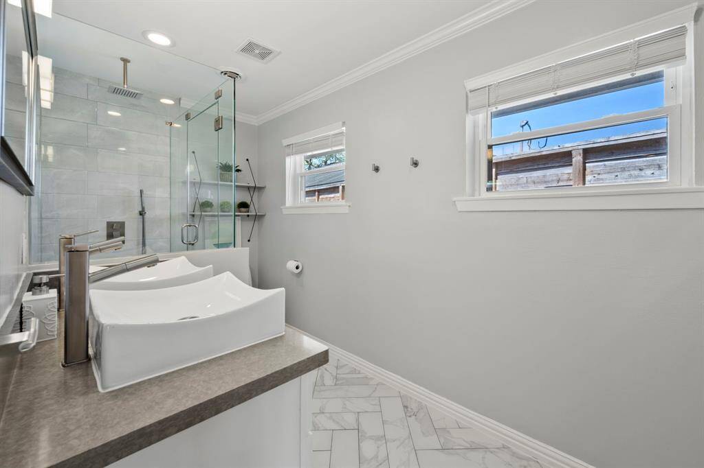 Primary bathroom features dual vanities.