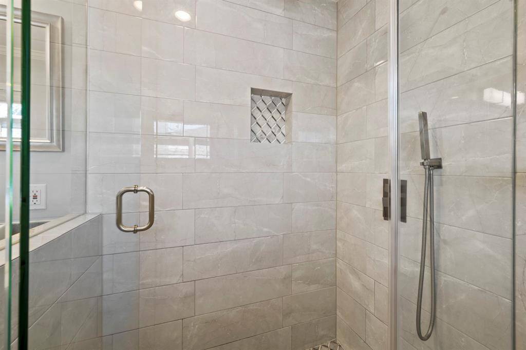 The glass shower of the primary bathroom.