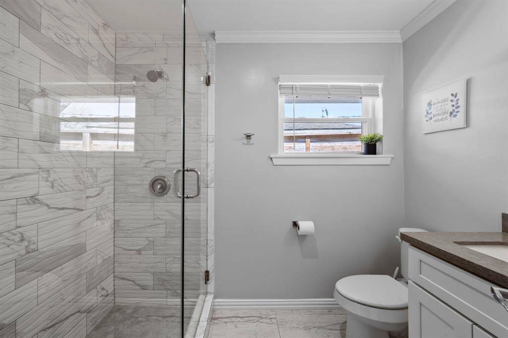 Bathroom number three features a beautiful glass shower.