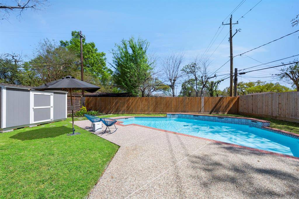 The perfect setting for outdoor entertaining, with a sparkling pool, ample seating, and lush green space—just in time for summer enjoyment.