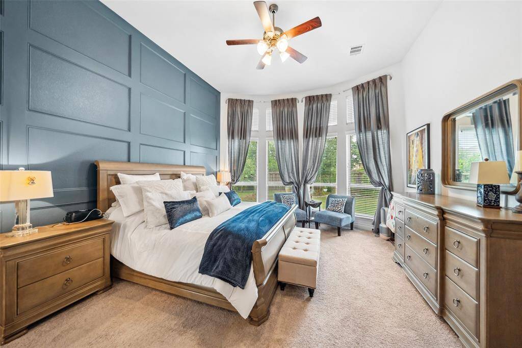 This primary bedroom has a sitting area