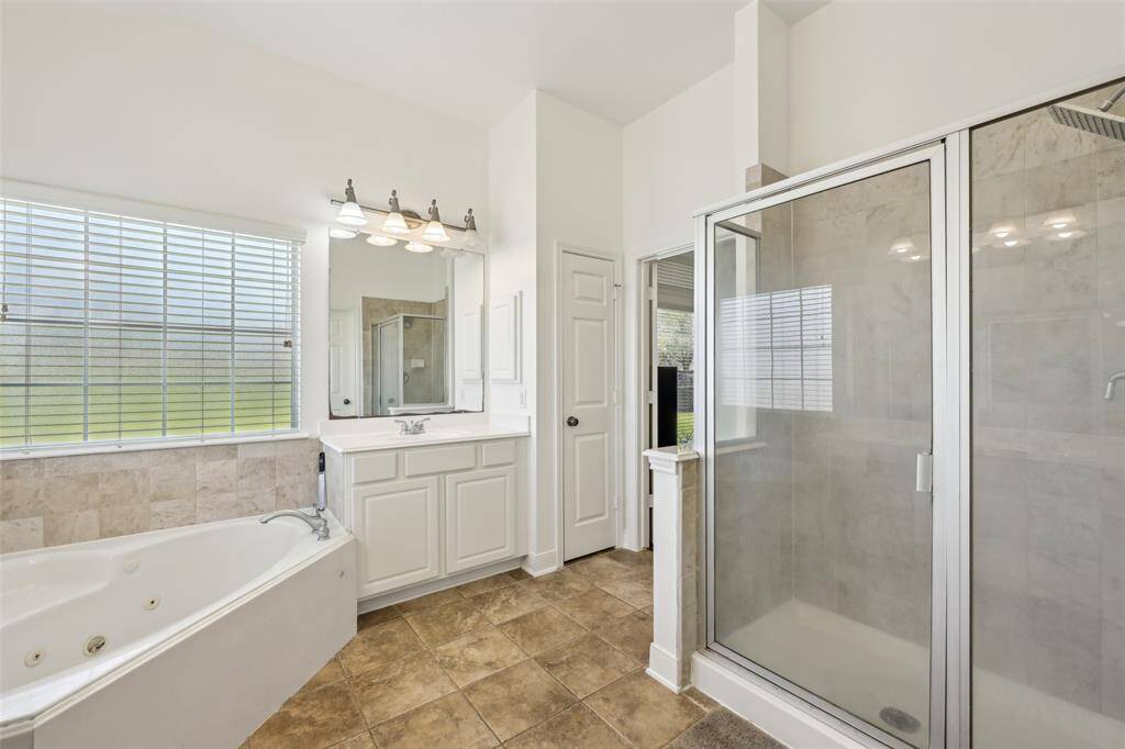 Luxurious primary bedroom, virtually staged to showcase its spacious layout and abundant natural light.