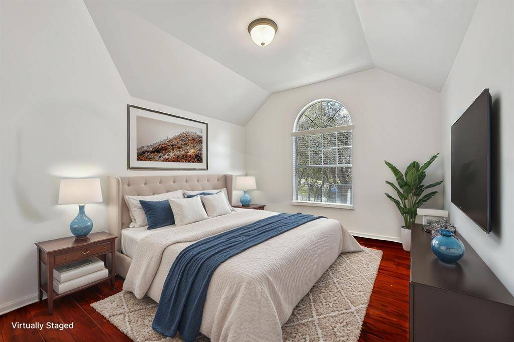 Primary bathroom featuring a spacious walk-in shower, soaking tub, and elegant vanity. Enjoy abundant natural light and serene views through large windows.