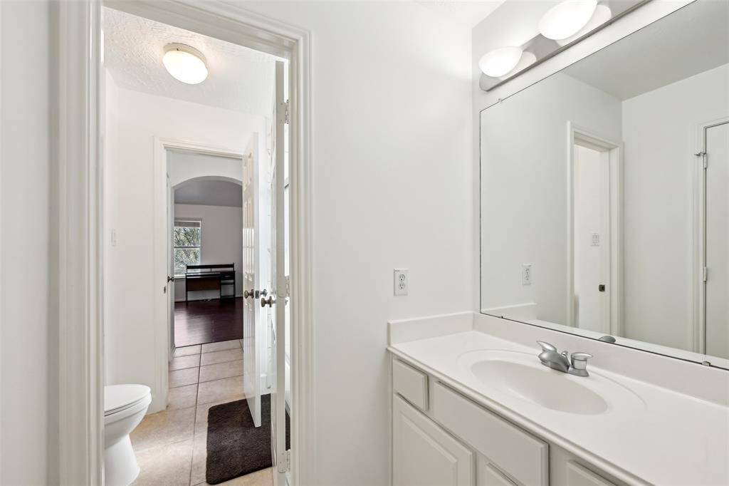 Secondary bedroom with abundant natural light, charming decor, and space for personalization. Virtually staged.