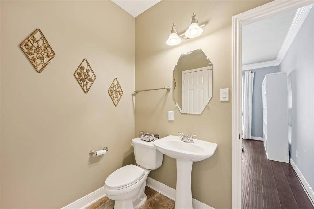 Bright and inviting home office with large window views, elegant French doors, and ample shelving for organization. Ideal for productivity and focus.