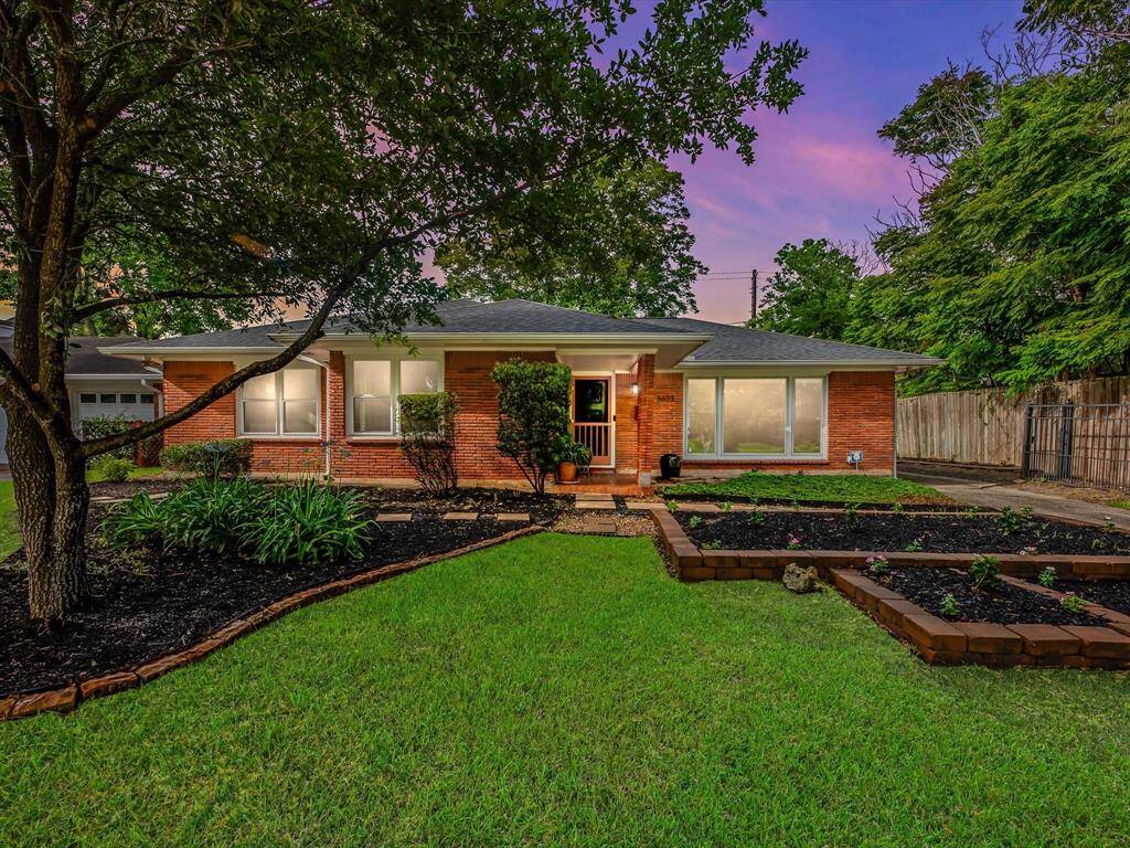 Charming twilight view of 3623 Deal Street, highlighting its inviting ambiance and beautifully landscaped front yard.