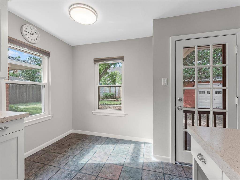 Bright breakfast nook with large windows, offering a cozy space to enjoy your morning coffee while overlooking the backyard.