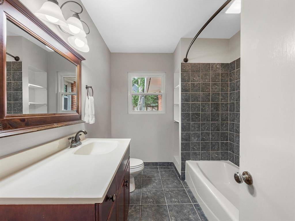Spacious full bathroom conveniently located off the bedroom entrance.